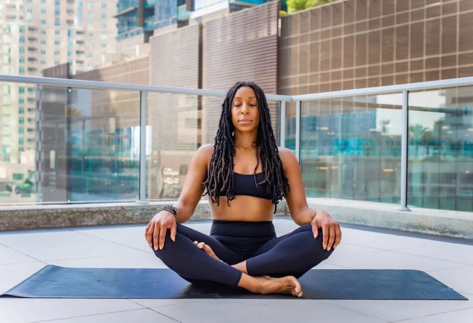 a woman meditating at her new home
